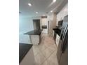 Bright kitchen with stainless steel appliances, an island, and granite countertops at 13244 Satin Lily Dr, Riverview, FL 33579