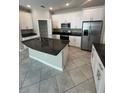 Modern kitchen featuring stainless steel appliances, granite countertops, and white cabinets at 13244 Satin Lily Dr, Riverview, FL 33579