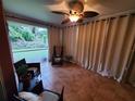 A cozy, screened patio space with tile flooring, seating, and natural lighting, perfect for relaxing at 1835 Rival Ter, North Port, FL 34286