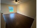 Living room featuring wood flooring and a ceiling fan, with lots of natural light at 3805 N Cranberry Blvd, North Port, FL 34286