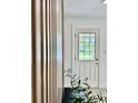 Light-filled entryway with a wood accent wall and stylish front door at 38706 8Th Ave, Zephyrhills, FL 33542