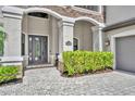 Charming home entrance featuring a decorative front door, address plaque, and lush greenery at 5531 Arnie Loop, Bradenton, FL 34211