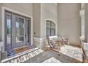 Inviting front porch with seating, decorative door, and stylish welcome mat at 5531 Arnie Loop, Bradenton, FL 34211