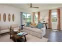 Inviting living room with stylish furnishings, lots of natural light, and access to outdoor space at 42862 Park View Dr, Punta Gorda, FL 33982