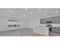 Bright kitchen featuring gray cabinets, stainless appliances, and island at 17322 Alderwood Ln, Punta Gorda, FL 33982