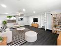 Bright and airy living room with recessed lighting, wood-look floors, and a neutral color palette at 5001 S 88Th St, Tampa, FL 33619