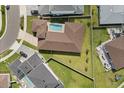 Aerial view of house with large fenced yard featuring a private in-ground pool and brick paved backyard patio at 8297 Ivy Stark Blvd, Wesley Chapel, FL 33545