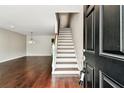 View of the foyer with beautiful hardwood floors and stairs leading to the upper level at 609 S Glen Ave # E, Tampa, FL 33609