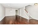 Spacious living room featuring hardwood floors with stairs leading to the upper level at 609 S Glen Ave # E, Tampa, FL 33609