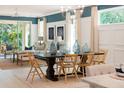 Elegant dining room with modern lighting, a large dining table, and seating for six at 1079 Signet, Apollo Beach, FL 33572