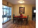 Cozy dining area with wood floors and sliding glass doors to the sunroom at 3680 Whiting Se Dr, St Petersburg, FL 33705