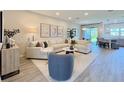 Inviting living room with comfortable seating, modern decor, and an open layout connecting to the dining area at 4171 Via Sienna Cir, Sarasota, FL 34243