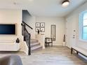 Modern living area featuring a staircase, stylish furnishings, and contemporary decor with an inviting ambiance at 4171 Via Sienna Cir, Sarasota, FL 34243