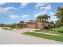 Stunning house with a 3-car garage, brick driveway and lush landscaping at 20323 Granlago Dr, Venice, FL 34293