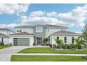 Beautiful two-story home showcasing a modern elevation, well-manicured lawn, and two-car garage at 9201 Sanders Tree Loop, Wesley Chapel, FL 33545