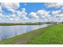 Picturesque pond surrounded by lush greenery, offering a tranquil and scenic view within the community at 17127 Harvest Moon Way, Bradenton, FL 34211