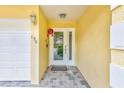 Inviting entryway with decorative tile floor and storm door with sidelights at 150 Brent Cir, Oldsmar, FL 34677