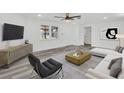Bright living room with modern furnishings, wood floors, neutral walls, and natural light at 456 Sandlewood Dr, Venice, FL 34293