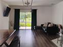Modern living room showcasing a sleek black couch, wood floors, and natural light at 5150 San Palermo Dr, Bradenton, FL 34208