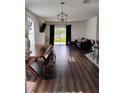Bright living room featuring hardwood floors, stylish furniture, and sliding glass doors at 5150 San Palermo Dr, Bradenton, FL 34208