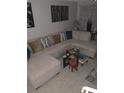 Cozy living room showcasing a large sectional sofa, glass table, and decorative accents at 6640 121St Ave # 1, Largo, FL 33773