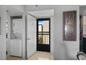 The entryway features a washer/dryer, and a black security door that allows natural light to brighten the interior at 9860 62Nd N Ter # 1047, St Petersburg, FL 33708