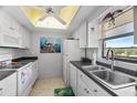 The kitchen features white appliances, dark countertops, and a window that provides natural light and ventilation at 9860 62Nd N Ter # 1047, St Petersburg, FL 33708