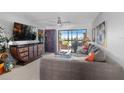Spacious living room with a comfortable gray sofa, large windows, and stylish decor at 9860 62Nd N Ter # 1047, St Petersburg, FL 33708
