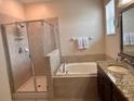 Spacious bathroom with separate shower and soaking tub, plus granite vanity top at 13642 Newport Shores Dr, Hudson, FL 34669