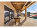 Covered patio area with outdoor seating overlooking the pool and backyard at 15340 Alsask Cir, Port Charlotte, FL 33981