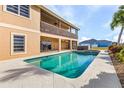 Outdoor pool and spa with a covered patio area and views of the yard at 15340 Alsask Cir, Port Charlotte, FL 33981