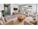Comfortable living room with neutral color palette and natural light, perfect for relaxing or entertaining guests at 4432 W Wallace Ave, Tampa, FL 33611