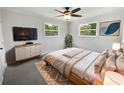 Cozy bedroom with ceiling fan, two windows, and natural light creates a peaceful retreat to enjoy a good night's rest at 4432 W Wallace Ave, Tampa, FL 33611