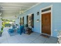 Inviting front porch with seating, ceiling fans, and a decorative lion statue by the wooden door at 8407 Interbay Blvd, Tampa, FL 33616