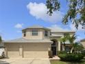 Charming two-story home with three car garage, manicured lawn and mature landscaping at 11356 Callaway Pond Dr, Riverview, FL 33579