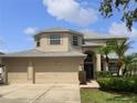 Charming two-story home with three car garage, manicured lawn and mature landscaping at 11356 Callaway Pond Dr, Riverview, FL 33579