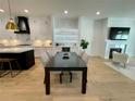Open concept dining area adjacent to a modern kitchen, filled with natural light and neutral colors at 1409 S Moody Ave # 1, Tampa, FL 33629