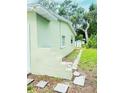 View of the side and rear of the home with a stone walkway and grassy area at 2731 Union S St, St Petersburg, FL 33712