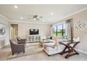 Bright and airy living room with elegant furnishings, a modern TV, and a decorative rug, creating a welcoming space at 13084 Rinella St, Venice, FL 34293