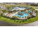 Aerial shot of community pool, splash pad, pool house, and palm trees at 5008 Sea Branch Ave, Apollo Beach, FL 33572