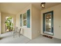 Cozy front porch with seating, shuttered windows, and a decorative front door, creating a welcoming entrance at 11402 Peckham Pl, Tampa, FL 33625