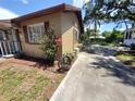 Spacious driveway alongside a charming home, landscaped with flowering bushes and greenery at 13 Euclid Dr, Plant City, FL 33563