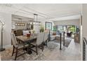 Elegant dining area with a modern chandelier, comfortable seating, and a view to the outdoor living space at 4203 Fairway Run, Tampa, FL 33618