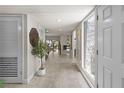 Bright and airy entryway with tile flooring, a decorative plant, and a textured glass window at 4203 Fairway Run, Tampa, FL 33618