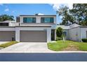 Inviting two-story home with a spacious driveway and lush green lawn on a sunny day at 4203 Fairway Run, Tampa, FL 33618