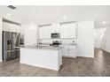 Bright kitchen featuring granite countertops, stainless steel appliances, and a functional kitchen island at 1844 Brekey Way, Zephyrhills, FL 33541