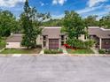 Charming condo exterior featuring a well-maintained facade and lush landscaping, unit 4 at 1200 Tarpon Woods Blvd # L4, Palm Harbor, FL 34685