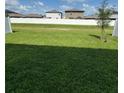 Spacious grassy backyard enclosed by a tall white fence, perfect for outdoor activities at 13707 Newbridge St, Spring Hill, FL 34609