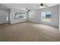 Expansive living area with neutral walls, large windows, and new carpeting at 16006 Stags Leap Dr, Lutz, FL 33559