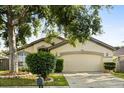 Charming one-story home with a well-maintained lawn, mature trees, and an attached two-car garage at 1716 Westerly Dr, Brandon, FL 33511